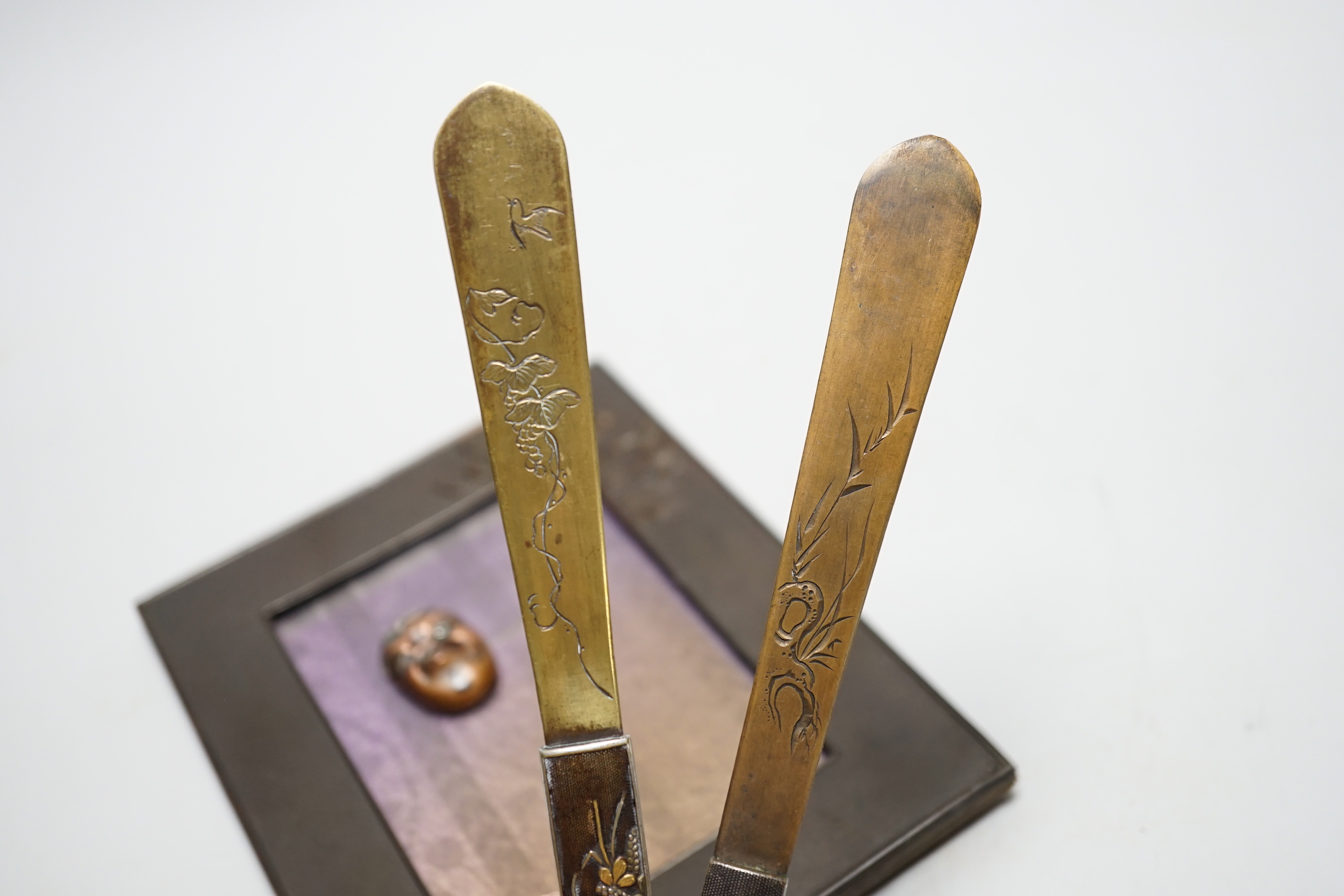 Four Japanese items comprising two mixed metal kazuka handles later converted to page turners, a photo frame and a noh mask mount, largest 21.5cm in length